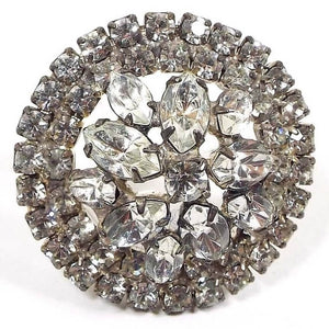 Front view of the 1950's Mid Century vintage rhinestone brooch pin. The metal is silver tone in color. There are two rows of round clear rhinestones all the way around the edge. The middle has various sizes of marquis shape clear rhinestones and there is one round clear rhinestone in the very middle. All rhinestones are prong set. 