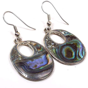 Front view of the retro vintage Mexican alpaca earrings with inlaid abalone shell. The metal is a slightly darker silver tone in color. The drops are oval shaped with a small oval cut out towards the top of them. They have pearly multi color abalone shell on the fronts.