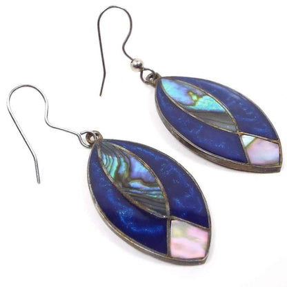Front view of the alpaca abalone earrings made in Mexico. The metal is a darker silver tone in color. The earwires are curved open french style hooks. The drops are marquis shaped and have inlaid abalone shell on the bottom and middle areas and pearly blue resin enamel around the edges.