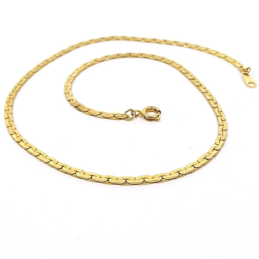 Top view of the retro vintage chain necklace. The C link chain is gold tone in color. There is a round spring ring clasp at the end.